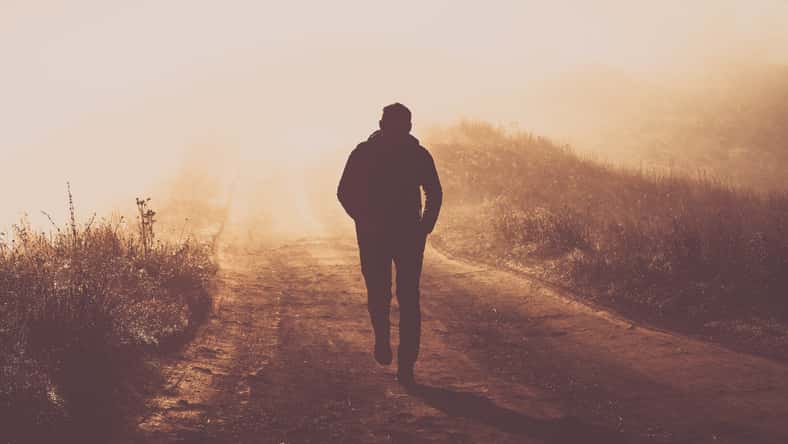man walking in a foggy autumn landscape