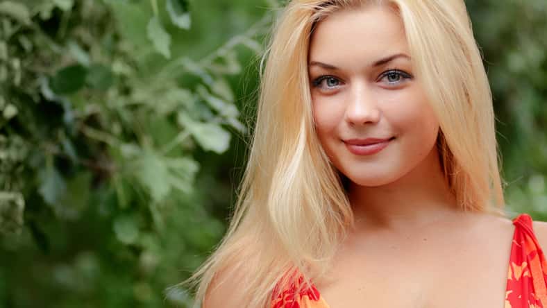 Close-up portrait of beautiful young woman with long blonde hair.