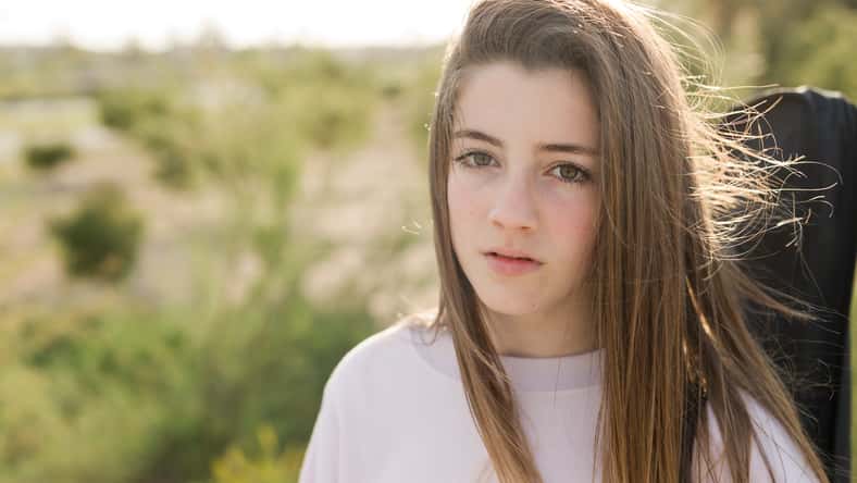 Portrait of a 15 year old teenage girl photographed in backlight
