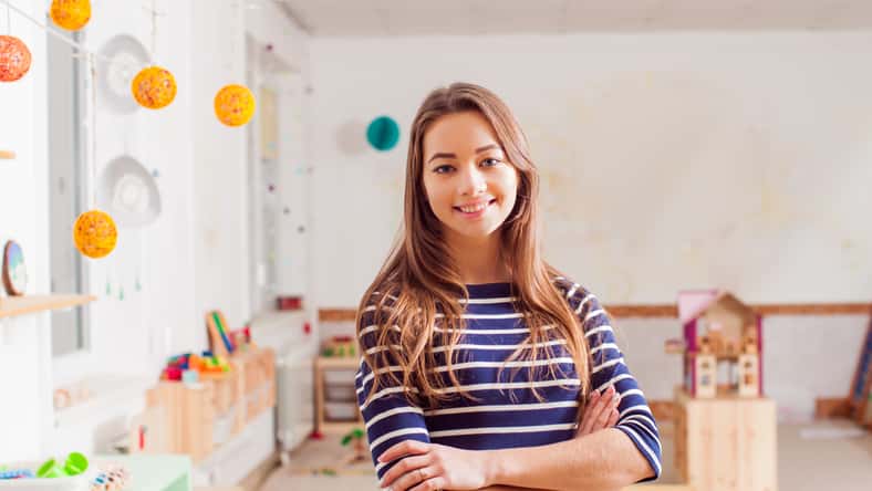Smiling young preschool teacher in a Waldorf kindergarten