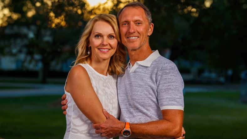 Attractive middle age couple outdoor lifestyle portrait in a park setting.