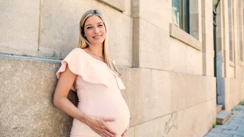 A Portrait of a pregnant woman in city street