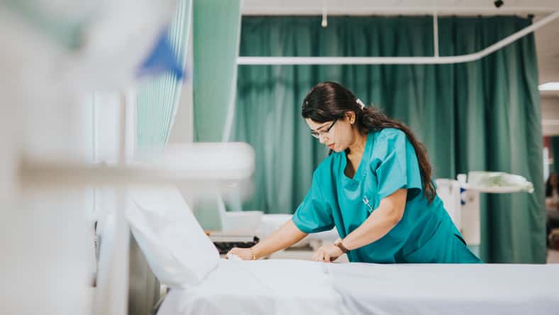Nurse making the bed at a hospital