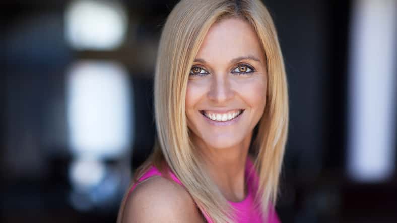 Portrait Of A Mature Woman Smiling At The Camera On a window background