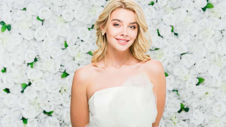 beautiful young woman with blonde hair on white floral background