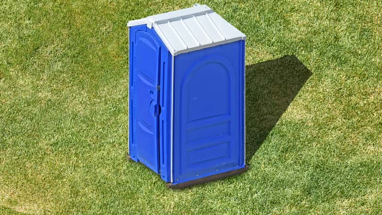 public portable plastic restroom cabin on green grass lawn aerial view of clean outdoor mobile toilet against nature background isolated bathroom lavatory exterior