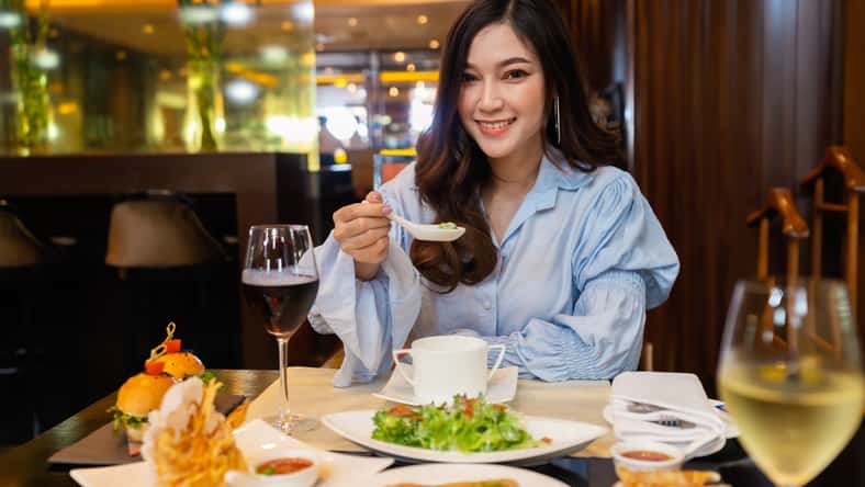 young beautiful woman eating in the restaurant