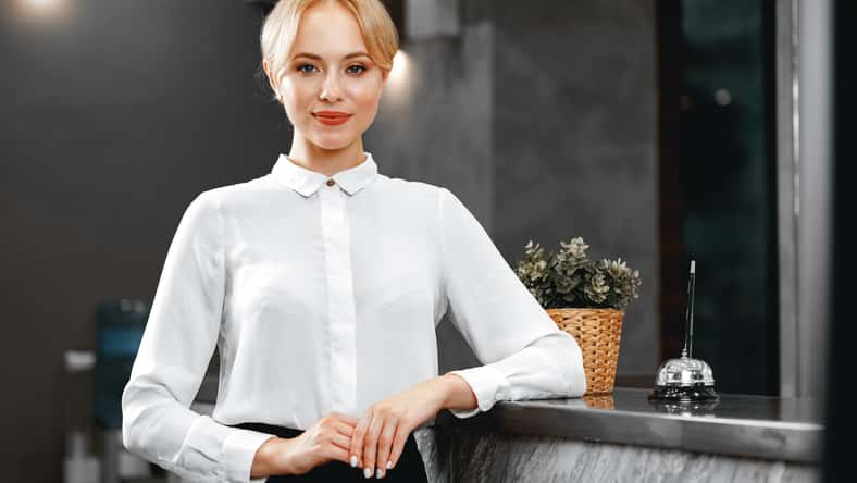 Portrait of beautiful blonde woman hotel receptionist