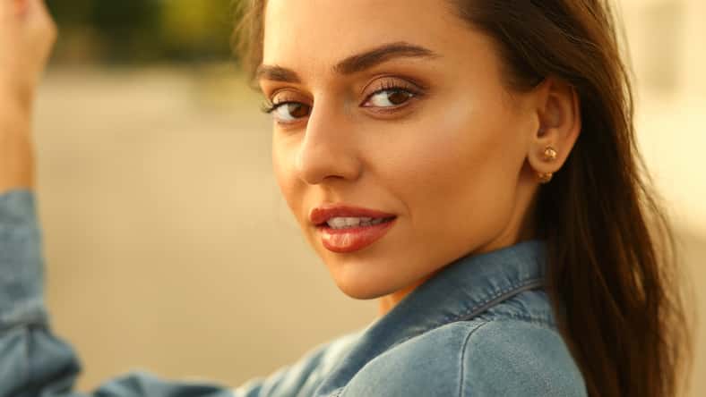 a gorgeous cute brunette smiles at the camera. portrait photos