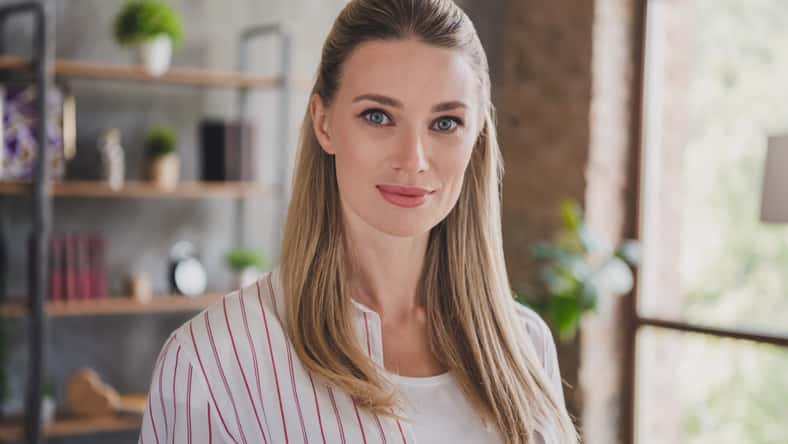 Photo of nice young blond lady wear white shirt at home alone.