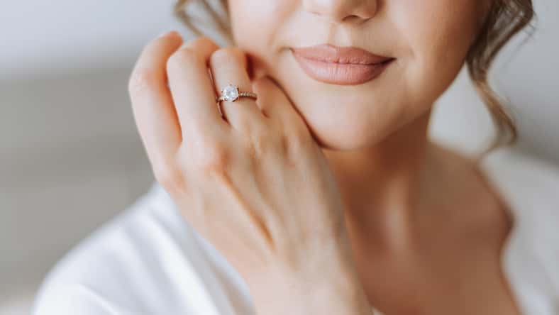 tender hands of a young woman with an expensive ring and a beautiful manicure. Close-up photo of female hands