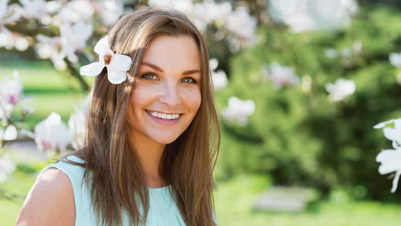beautiful woman in blossom park smiling