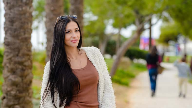 Portrait of beautiful smiling active woman walking