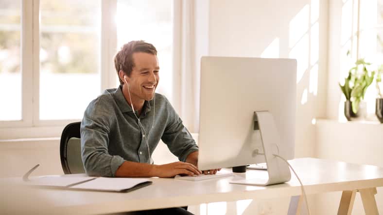 Smiling businessman working on computer. Man sitting
