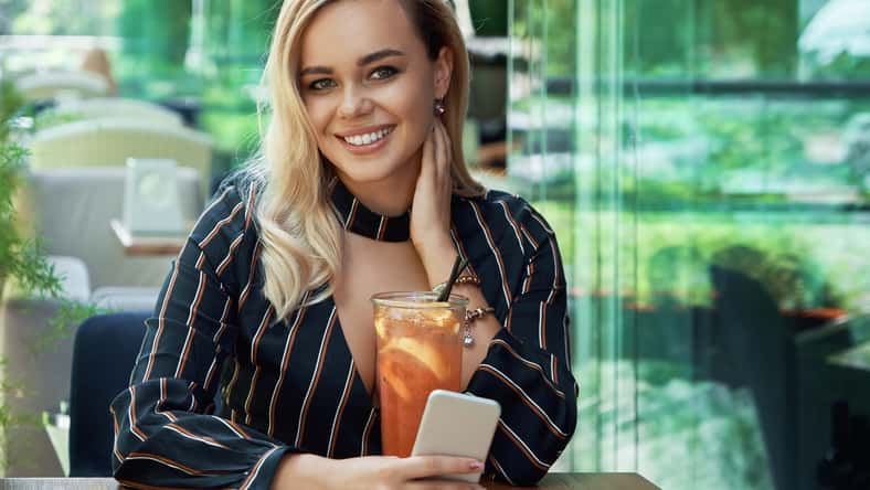 Portrait gorgeous woman holding phone in hand