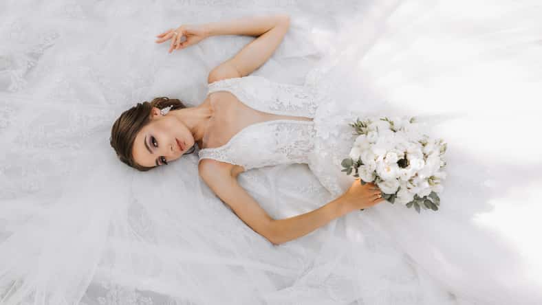 Beautiful bride with wedding bouquet of flowers,