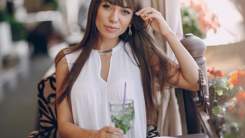 beautiful girl drinks mojito outside sunni weather