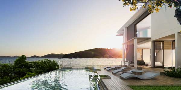a modern house on the water with a pool