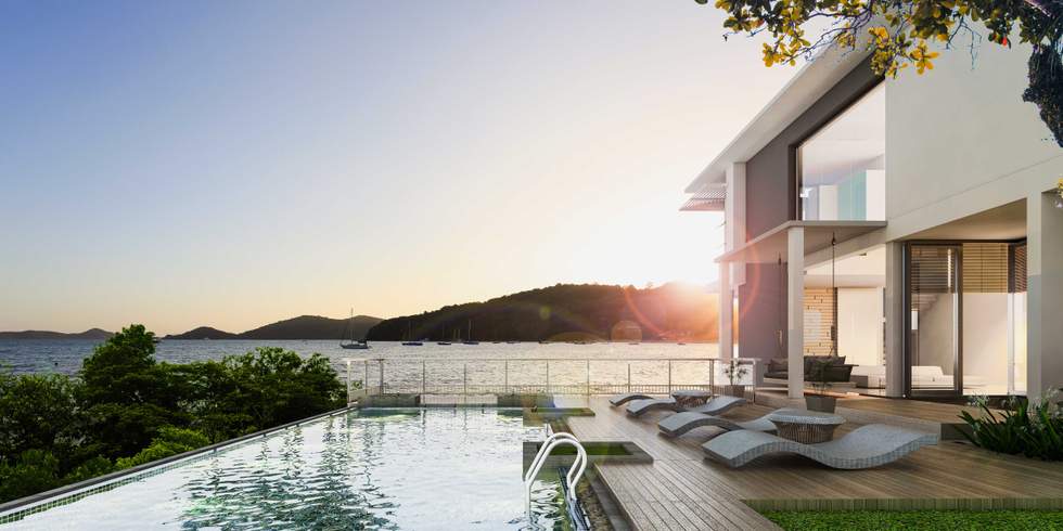 a modern house on the water with a pool