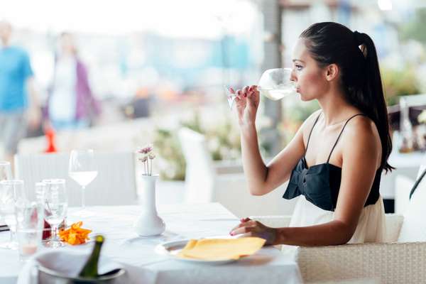 a woman drinking wine in a restaurant