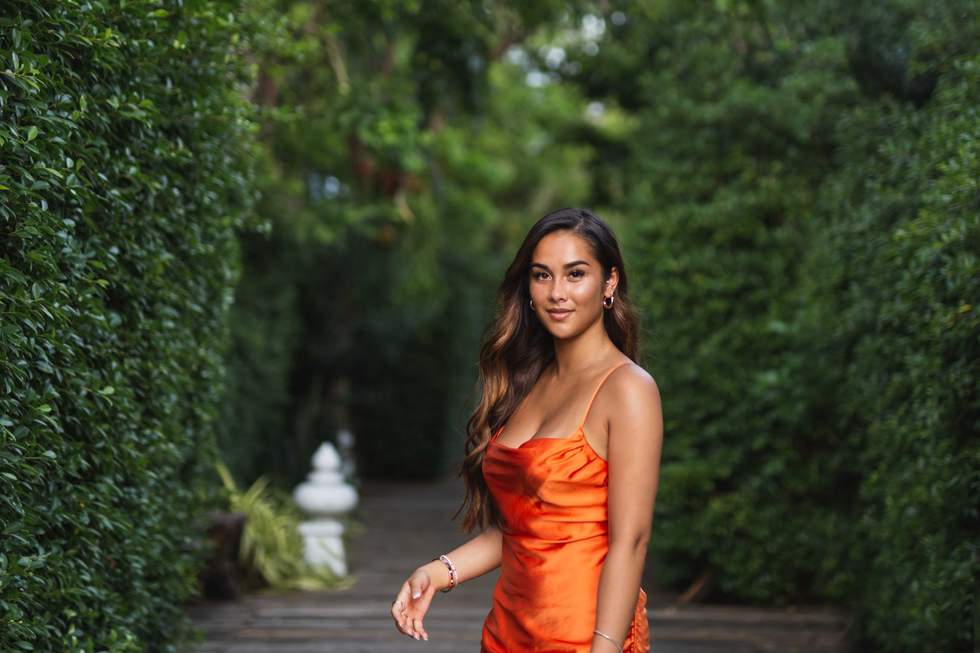 a woman in an orange dress outside