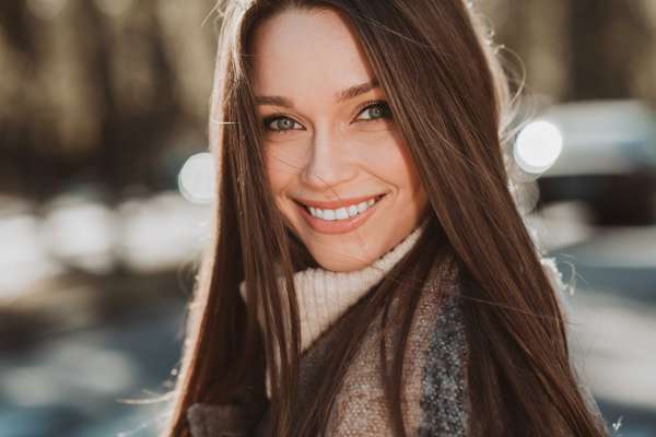 a woman smiling in a park