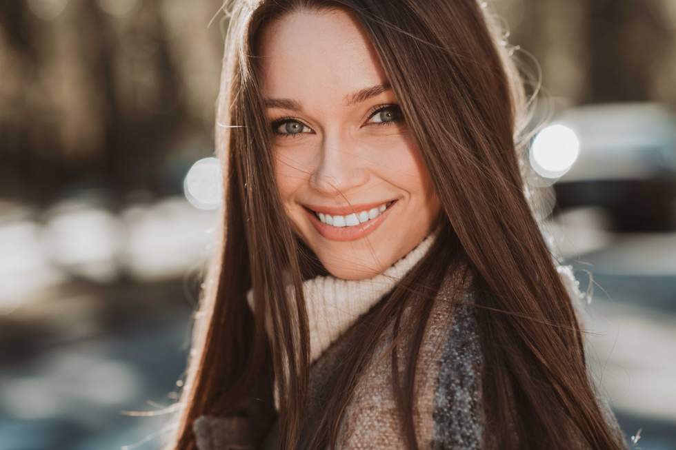 a woman smiling in a park