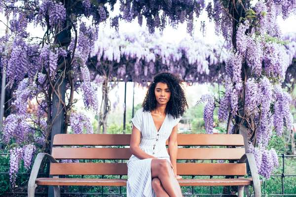 a woman surrounded by lilacs
