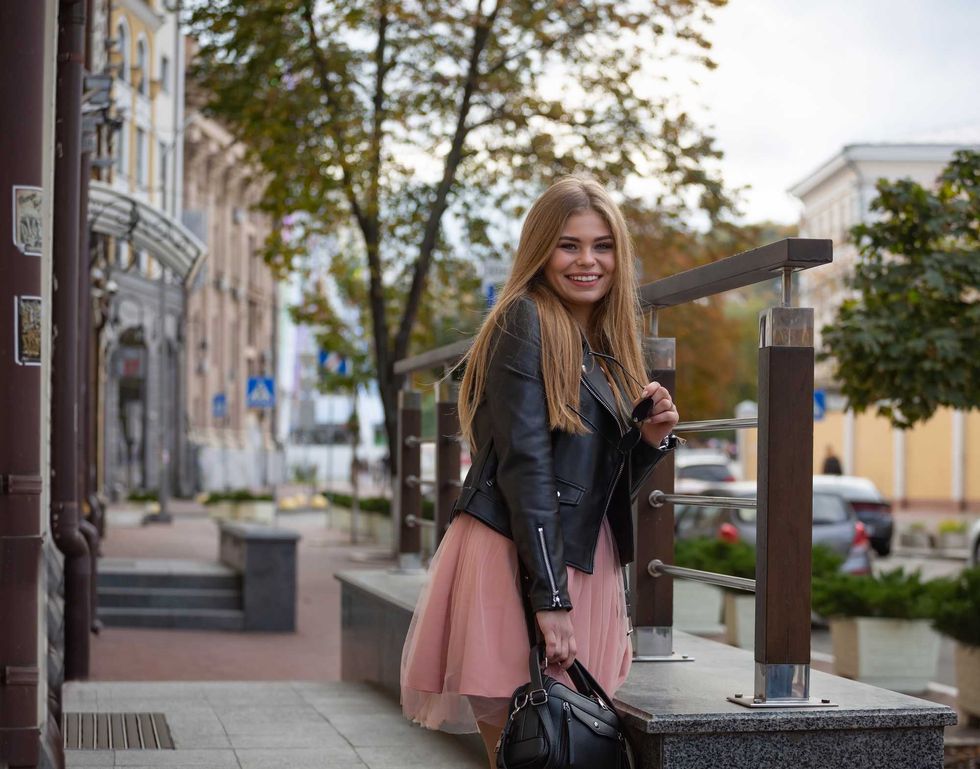 Beautiful smiling girl on the street of a modern city