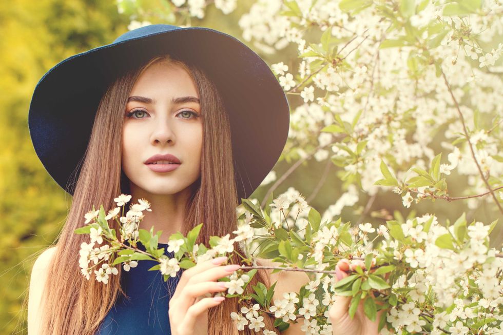 Beautiful woman in blue hat outdoors spring portrait