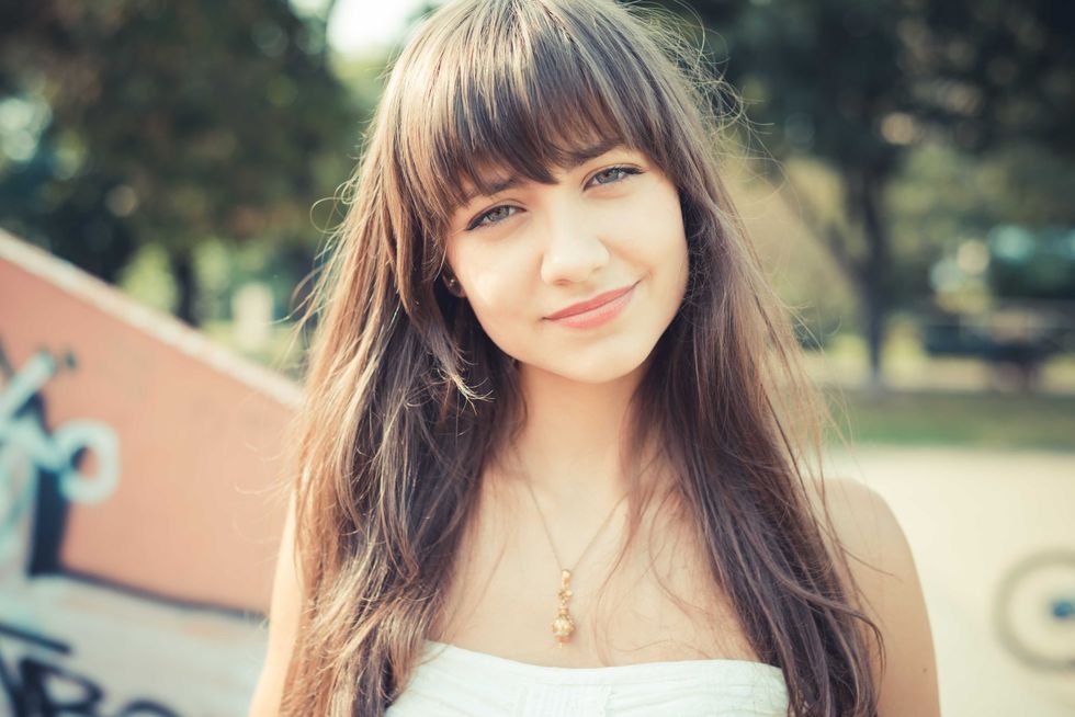 beautiful young woman with white dress in the city