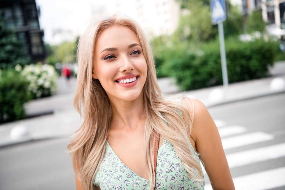 blonde woman crossing the street