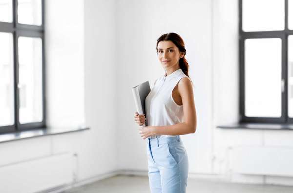 business, people and corporate concept - businesswoman or realtor with folder at office