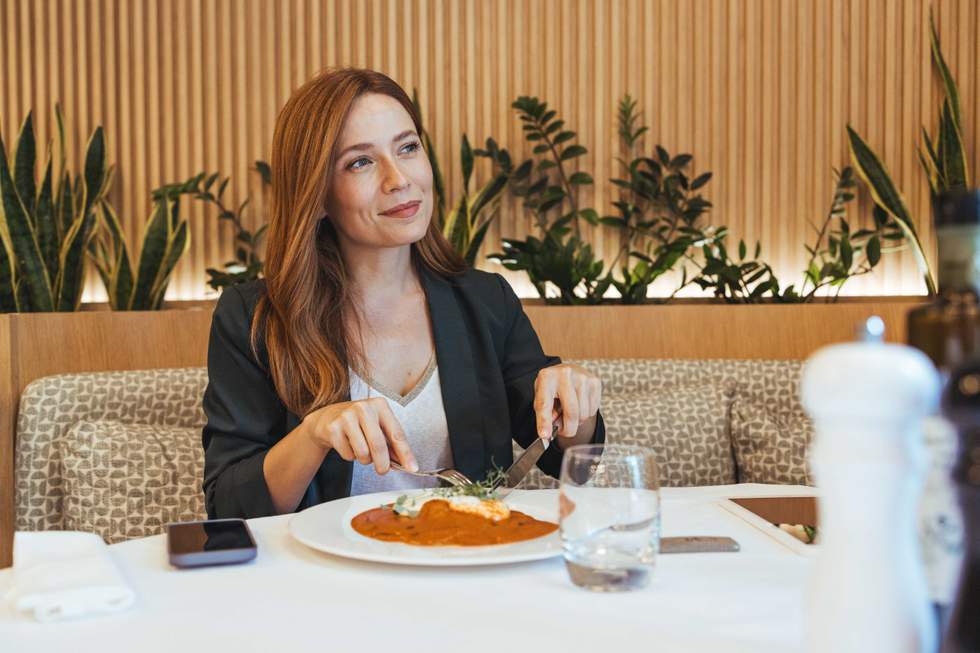 Businesswoman dining in modern restaurant