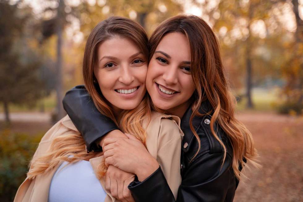 Closeup shot of two woman best friends in affectionate hug