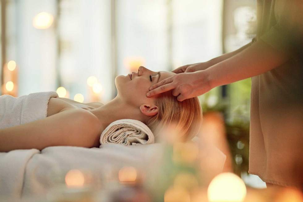 Cropped shot of a young woman enjoying a head massage at a spa.