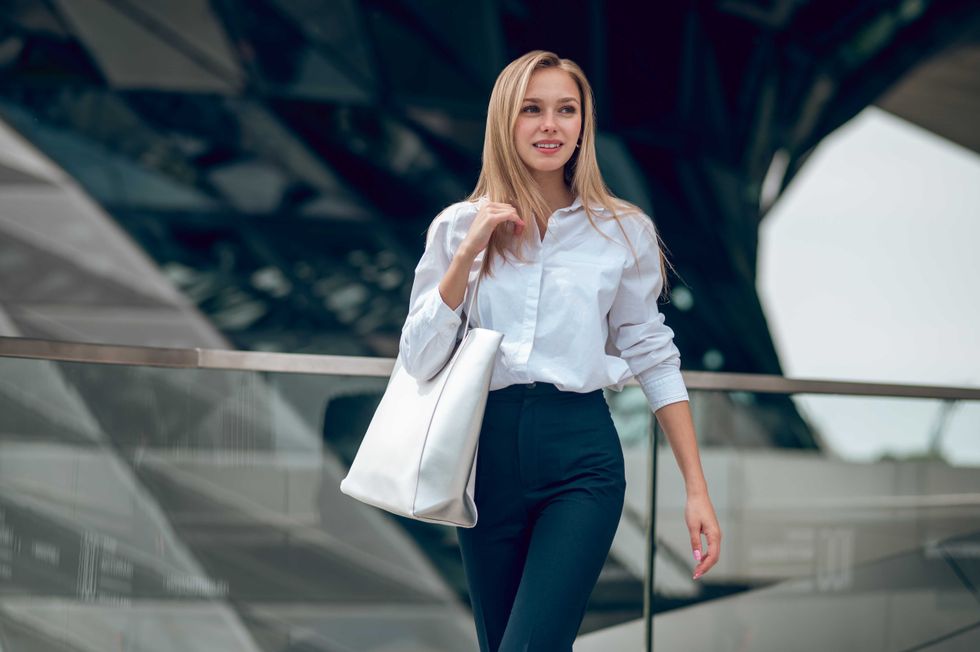 Elegance. Pretty elegant young business woman looking contented