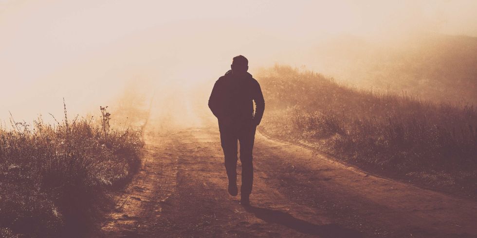 man walking in a foggy autumn landscape