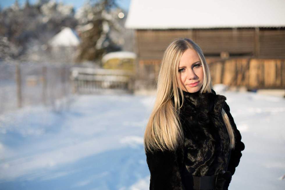 Outdoor portrait of young beautiful fashionable woman posing on street