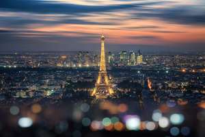 Paris city in the evening with the Eiffel tower and La Defense b