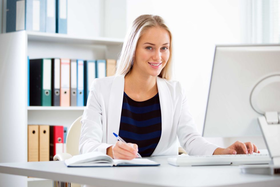 Portrait of a young business woman using computer at office