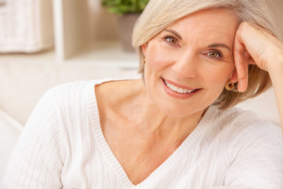 Portrait of an attractive elegant senior woman relaxing at home.