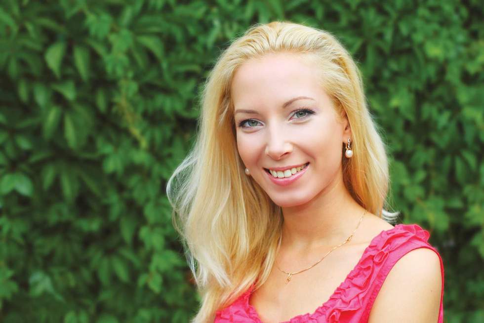Portrait of young pretty blond woman outdoors