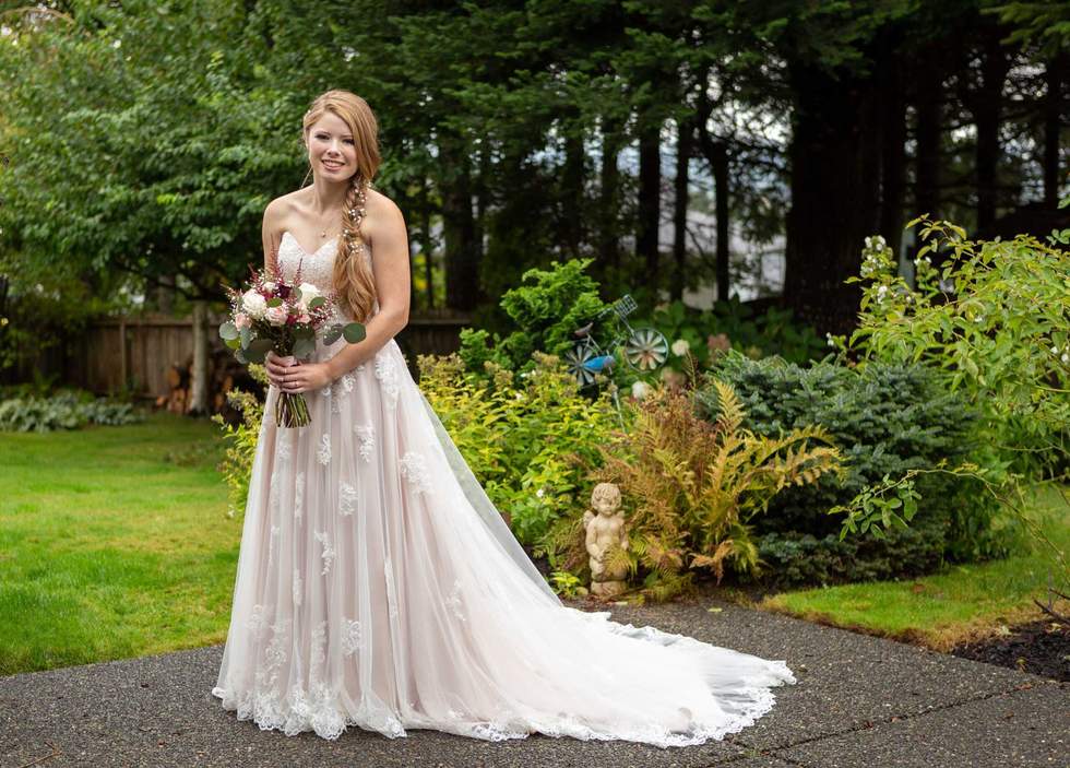 Pretty bride posing in backyard