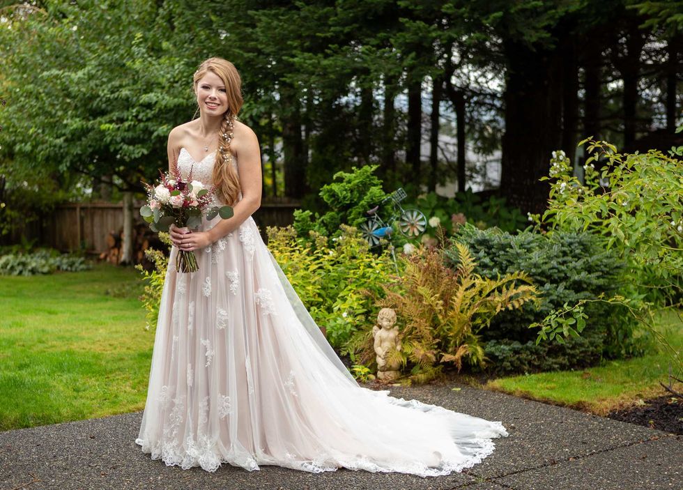 Pretty bride posing in backyard