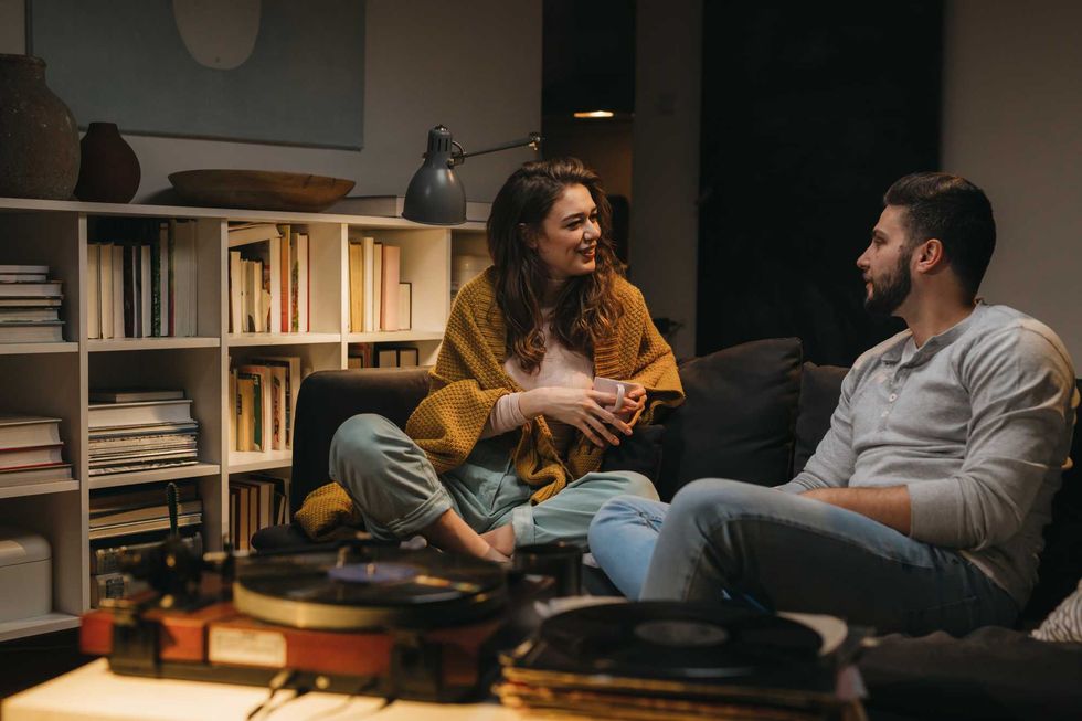 romantic couple listening to a music on record player at home