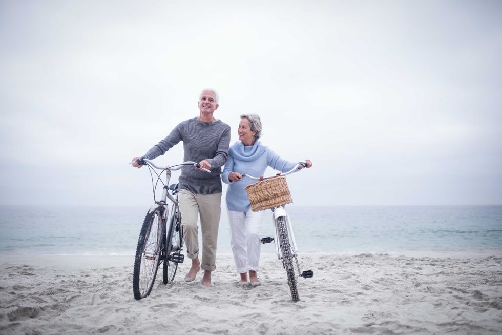 Senior couple having ride with their bike