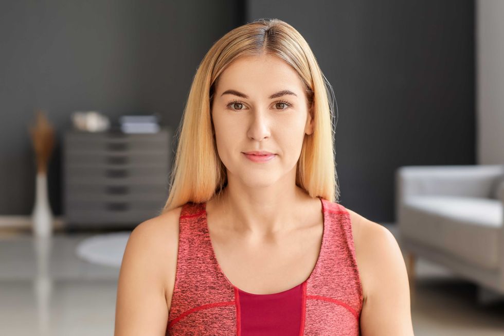 Sporty young woman training at home