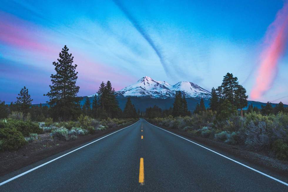 Sun setting on the road in the mountains