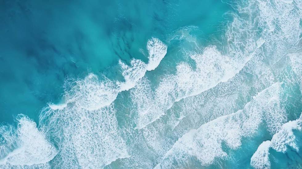 Waves on the beach as a background. Beautiful natural background at the summer time